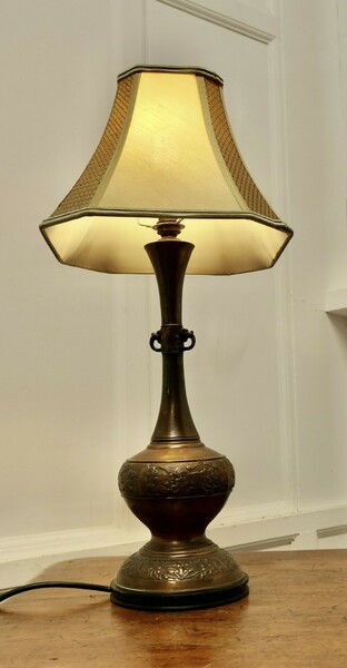 A Large Bulbous Embossed Copper Table Lamp photo furniture